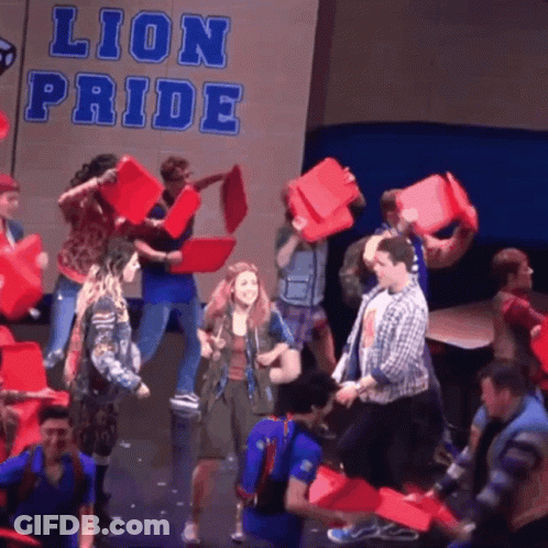 People Holding Red Buckets With Lion Pride Sign GIF