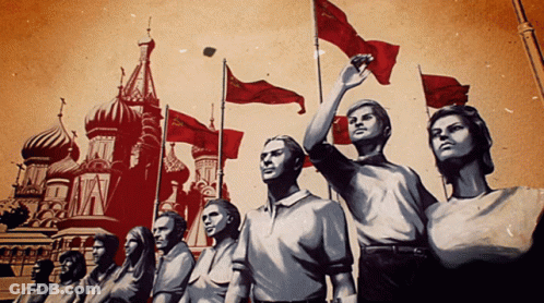 People Holding Red Flags Near Building With A GIF