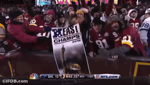 People Holding Sign Saying 40 In East Champ GIF