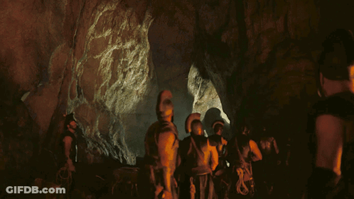 People In Cave With Helmets And Armor GIF