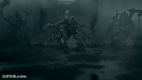People In Dark Room Before Monster Statue GIF