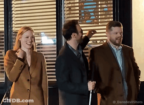 People In Front Of Window With Blinds GIF