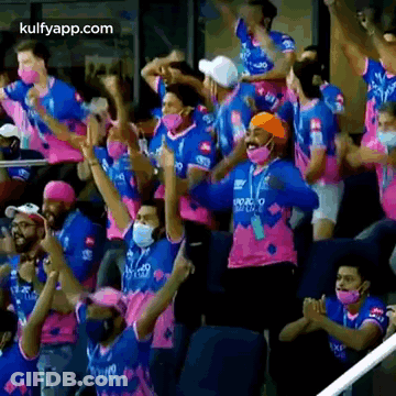 People In Masks Watching Cricket At Stadium GIF