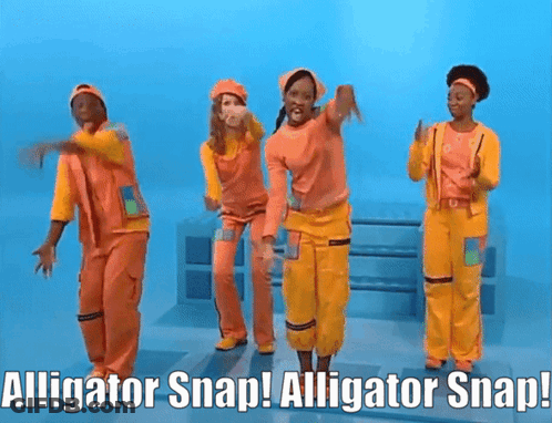 People In Orange And Yellow Jumpsuits Dancing With Alligator Snap GIF