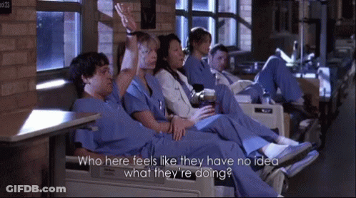 People In Scrubs Sitting In Chairs GIF