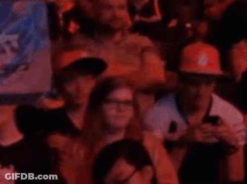 People In Stadium Watching Game On Phones GIF