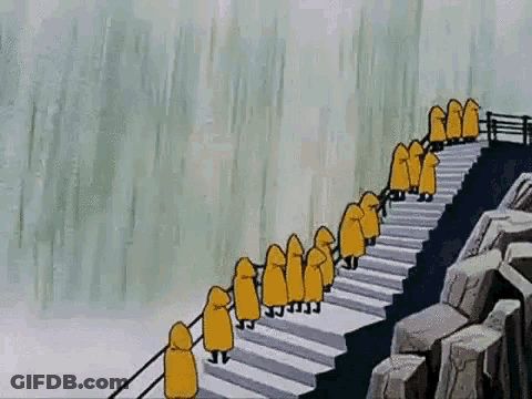 People In Yellow Raincoats On Stairs Near Waterfall GIF