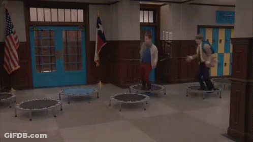 People Jumping On Trampolines In School Hallway GIF