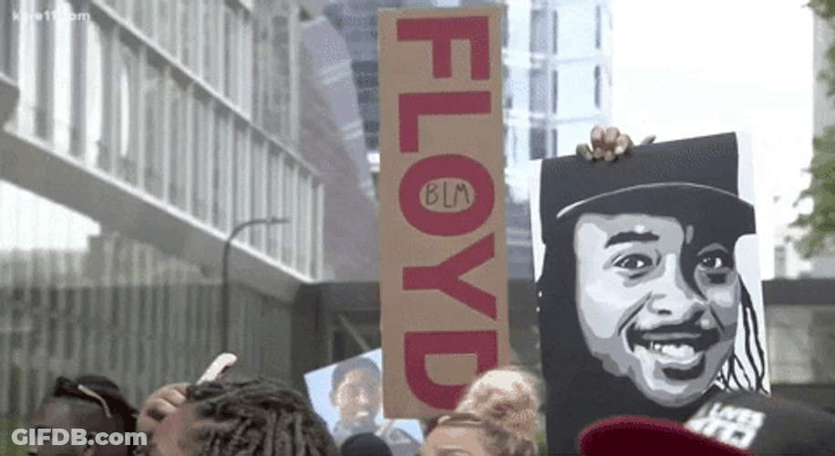 People Lifting Signs Related To George Floyd GIF