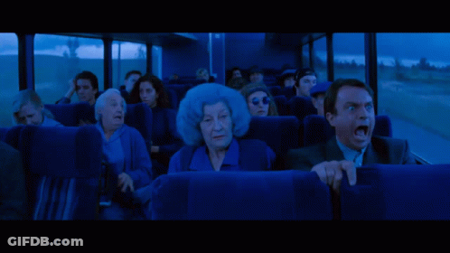 People Looking At Large Red Monster In Dark GIF