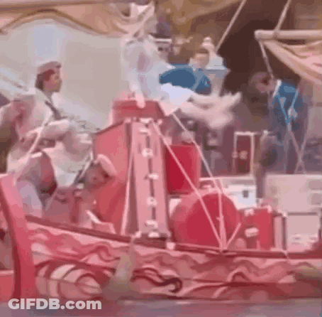 People On Red Boat In Parade GIF