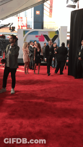 People On Red Carpet In Front Of JBL Sign GIF
