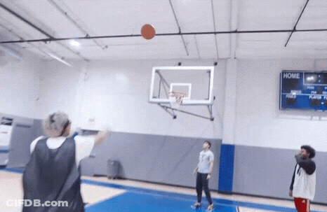 People Playing Basketball In A Gym With A Scoreboard That Says Home On It GIF