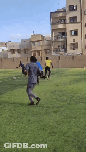 People Playing Soccer Near Building GIF