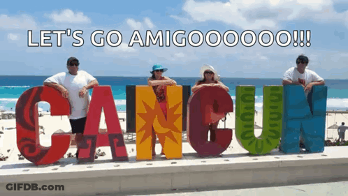 People Posing In Front Of Cancun Sign GIF