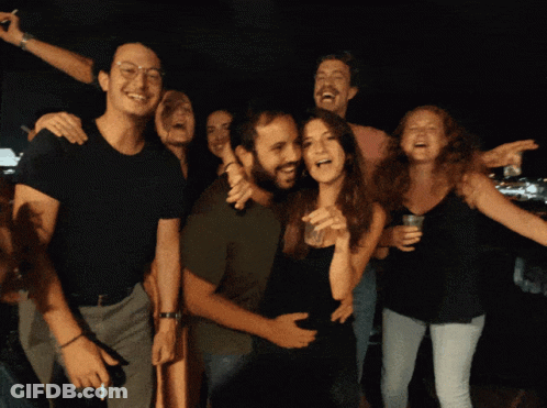 People Posing With Woman Holding Glass GIF