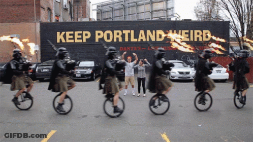 People Riding Bicycles Past Keep Portland Weird Sign GIF