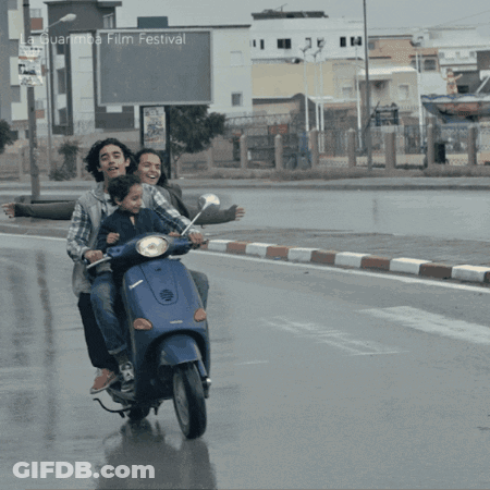 People Riding Scooter At La Guarimba Film Festival GIF