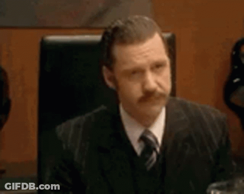 People Sitting Around Conference Table GIF