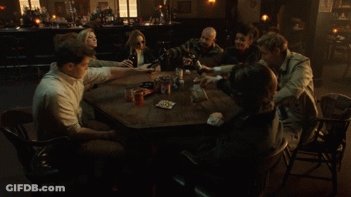 People Sitting Around Table In Dark Room GIF