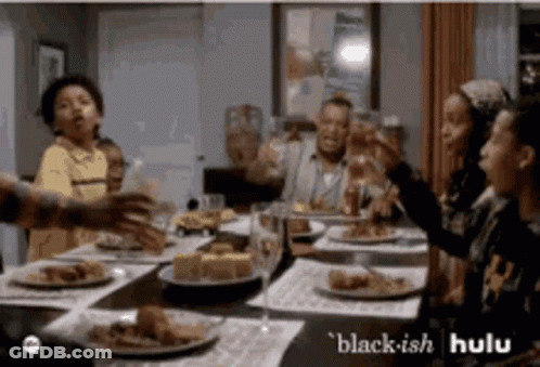 People Sitting Around Table With Food And Wine GIF