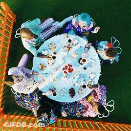 People Sitting Around Table With Food GIF