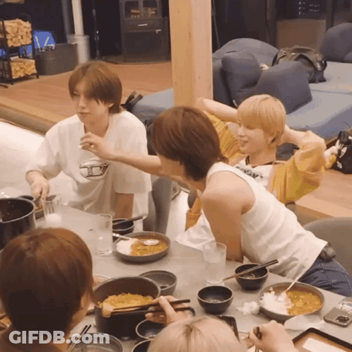 People Sitting At Table With Food Bowls GIF