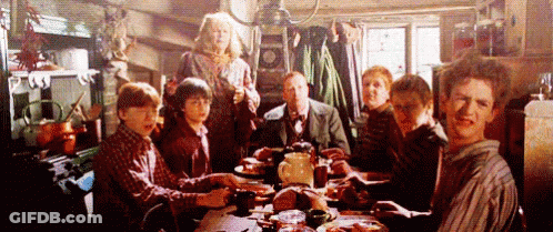 People Sitting At Table With Food Plates GIF
