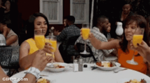 People Sitting At Table With Orange Juice GIF