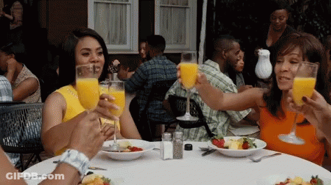People Sitting At Table With Orange Juice GIF