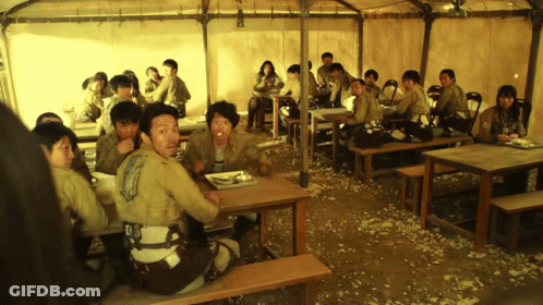 People Sitting At Tables Under Tent Eating GIF