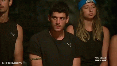 People Sitting In A Row With Blue Beanie GIF