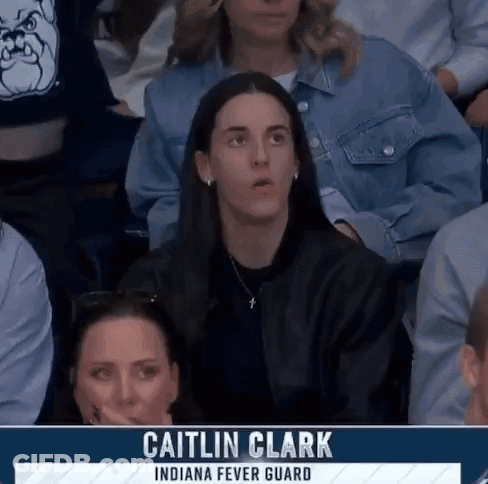 People Sitting In Stadium With Caitlin Clark On Screen GIF