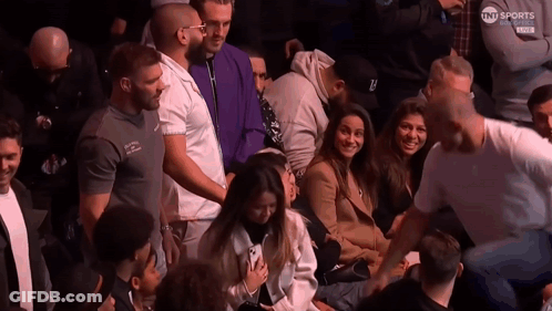 People Sitting In Stadium With TNT Sports Logo GIF