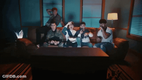 People Sitting On Couch Watching TV GIF
