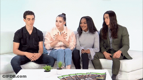 People Sitting On Couch With Entertainment Magazine GIF