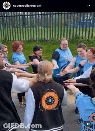 People Standing In Circle With Outstretched Arms GIF