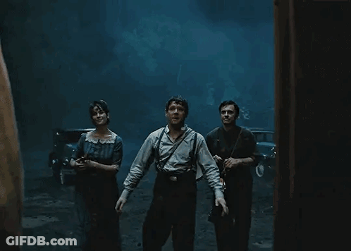 People Standing In Dark Room With Lantern GIF