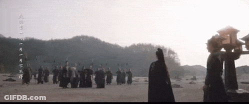 People Standing In Field With Chinese Writing GIF