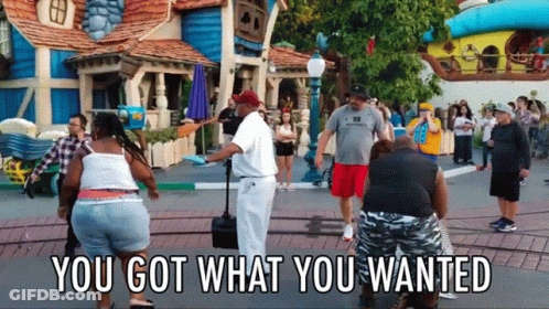 People Standing In Front Of Building Saying You Got What You Wanted GIF