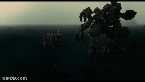 People Standing In Front Of Monster GIF