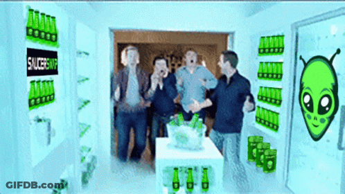 People Standing In Room With Saucershop Sign GIF