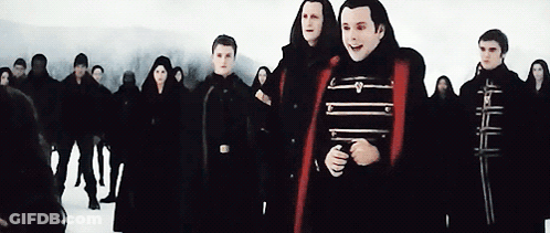 People Standing In Snow One Red Cape GIF