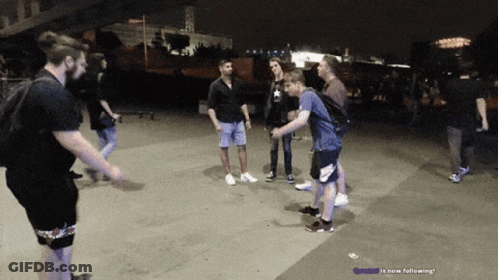People Standing On Sidewalk Saying Is Now Following GIF