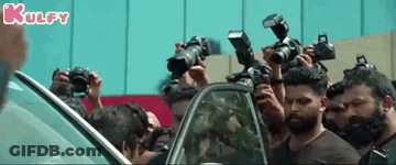 People Taking Photos Of Man By Car GIF