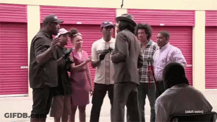 People Talking In Front Of Pink Garage Door GIF