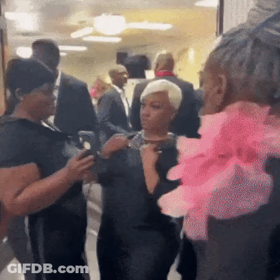 People Talking In Hallway Woman With Pink Flower GIF