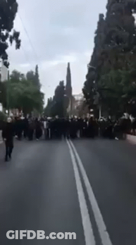 People Walking Down A Blurry Street GIF