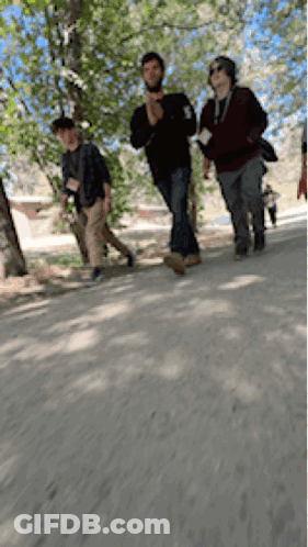 People Walking Down Dirt Road GIF