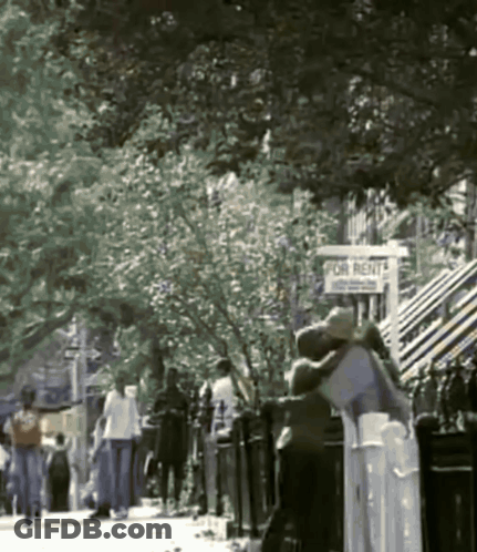 People Walking Down Street With For Rent Sign GIF